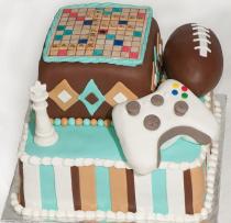 Game theme birthday cake with Scrabble board_ Chess King piece_ football and XBox 360 Controller.JPG